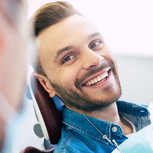 man smiling in dentists chair